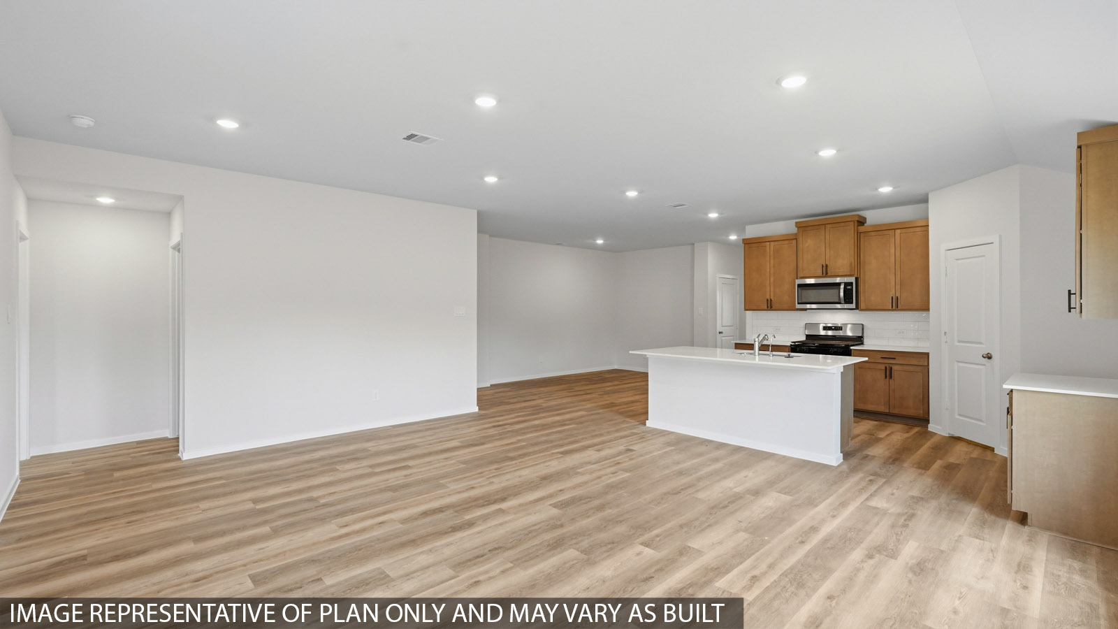 open concept living and dining area with large windows and vinyl flooring