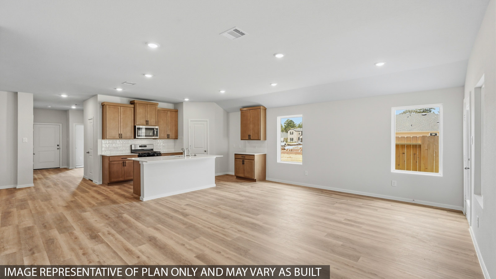 open concept living and dining area with large windows and vinyl flooring