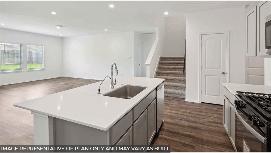 open concept living and dining area with viyl flooring, large windows, and quartz countertops in Magnolia, TX