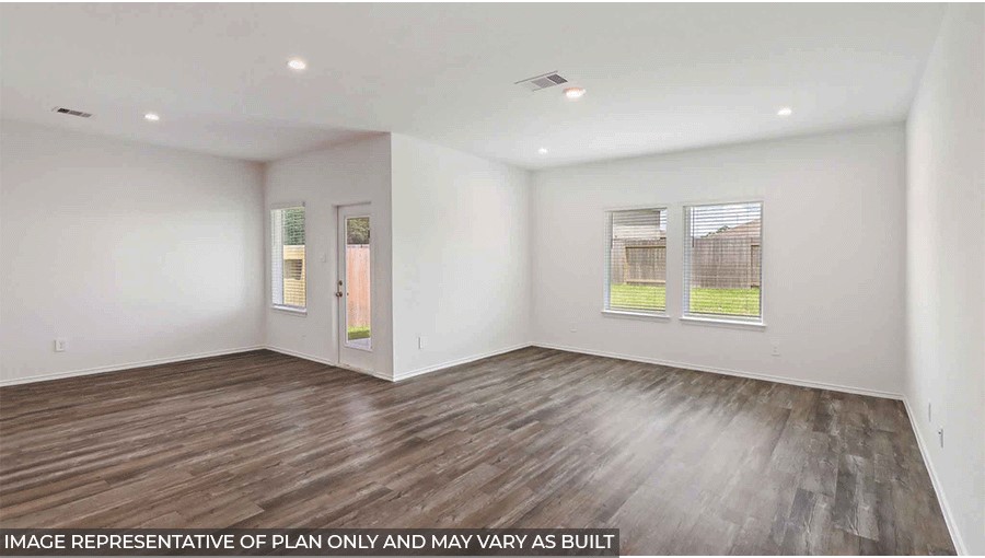 open concept living and dining area with viyl flooring, large windows, and quartz countertops in Magnolia, TX