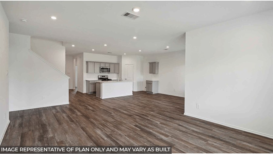 open concept living and dining area with viyl flooring, large windows, and quartz countertops in Magnolia, TX