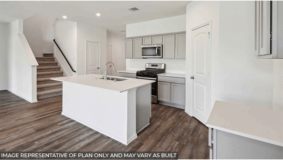 open concept living and dining area with viyl flooring, large windows, and quartz countertops in Magnolia, TX