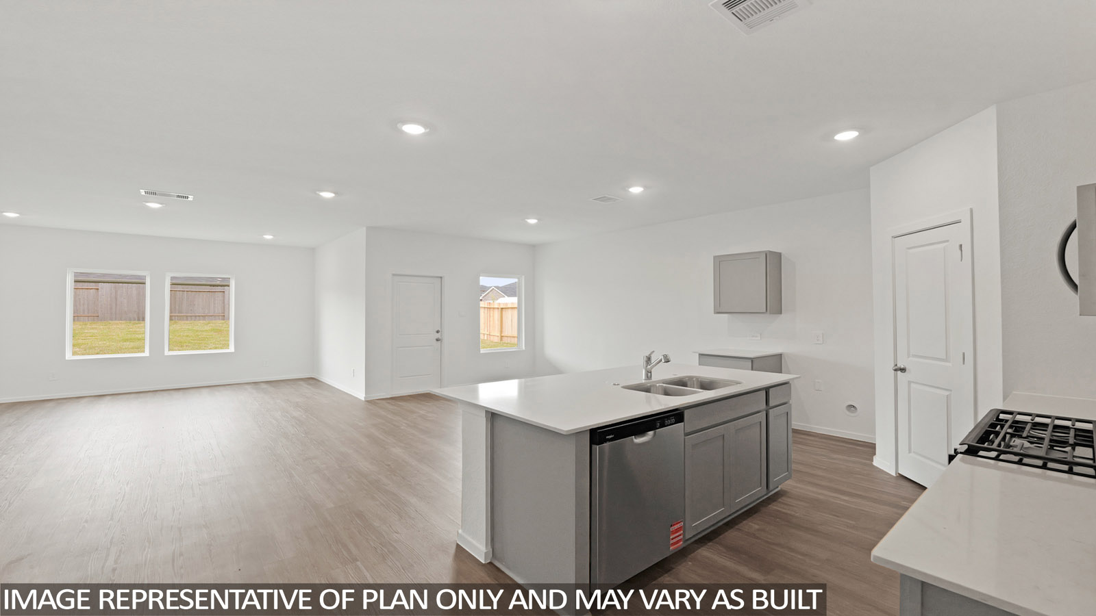 open concept living and dining area with vinyl flooring, stainless steel appliances, and quartz countertops