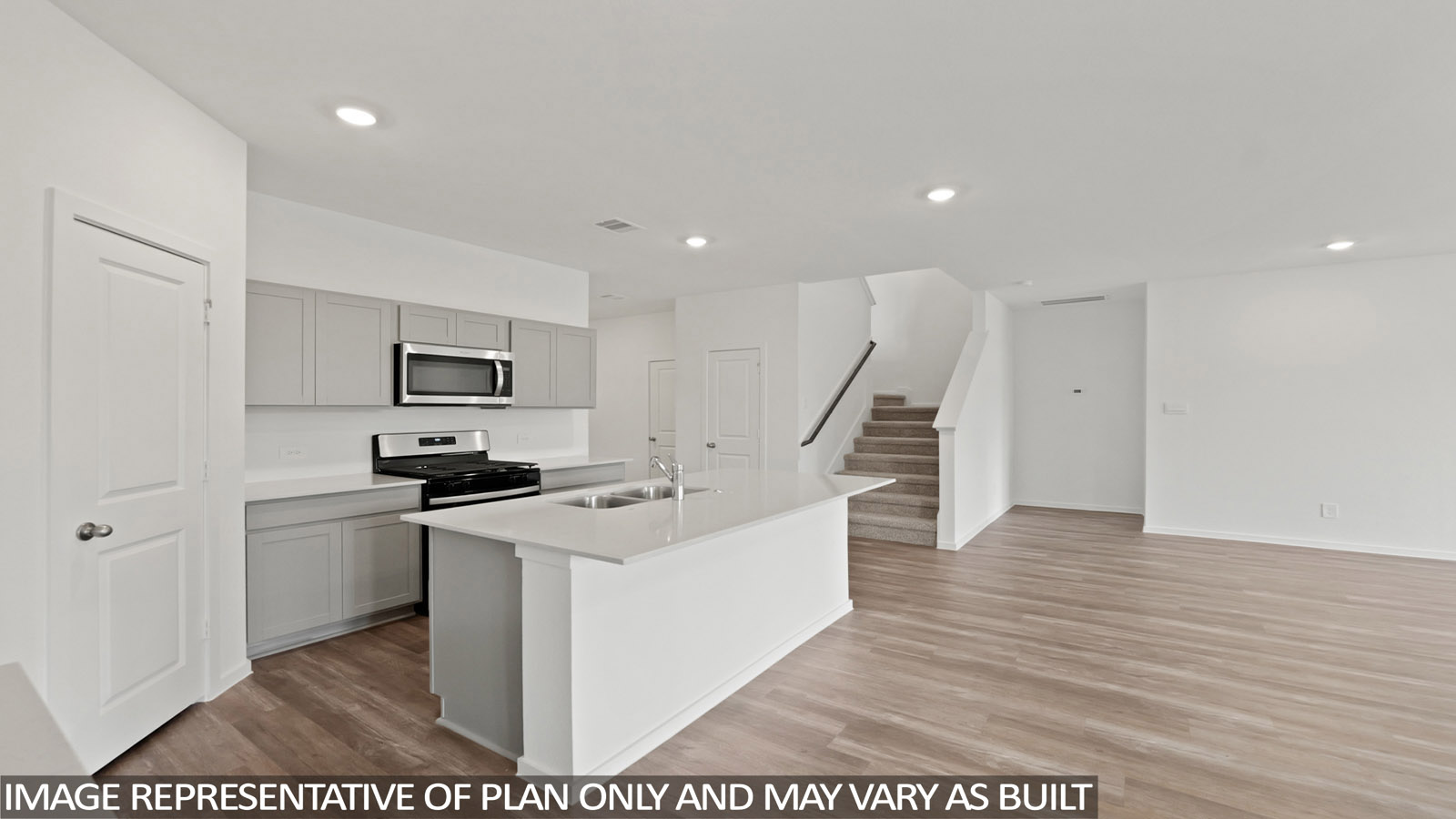 open concept living and dining area with vinyl flooring, stainless steel appliances, and quartz countertops