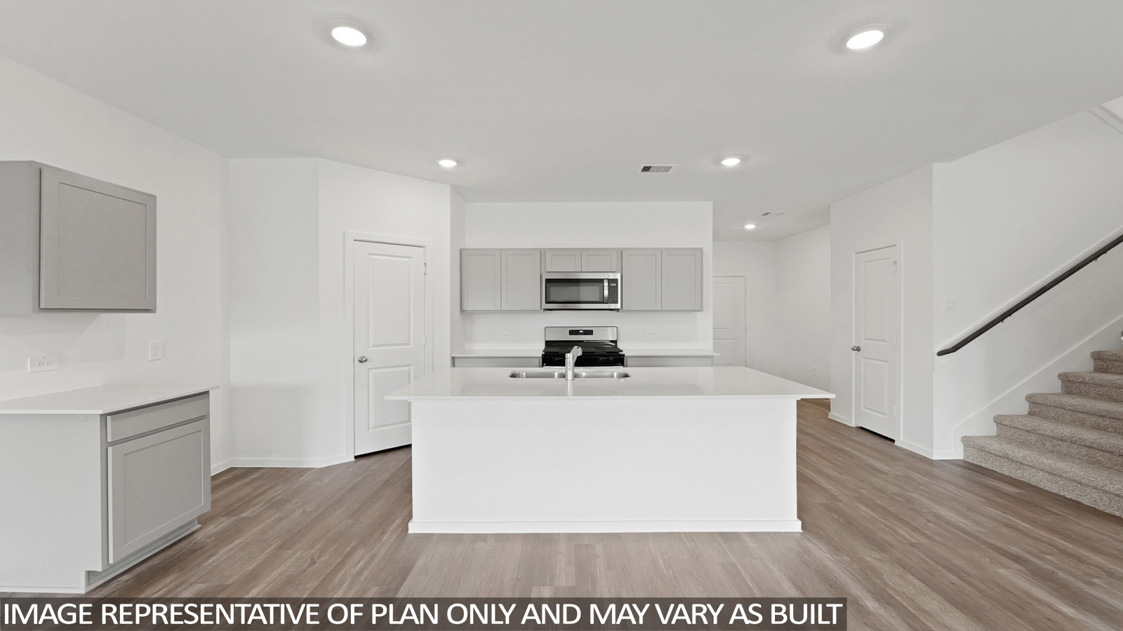 open concept living and dining area with vinyl flooring, quartz countertops, and stainless steel appliances
