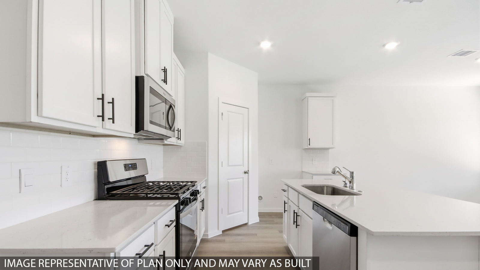 open concept living and dining area with vinyl flooring, quartz countertops, and stainless steel appliances
