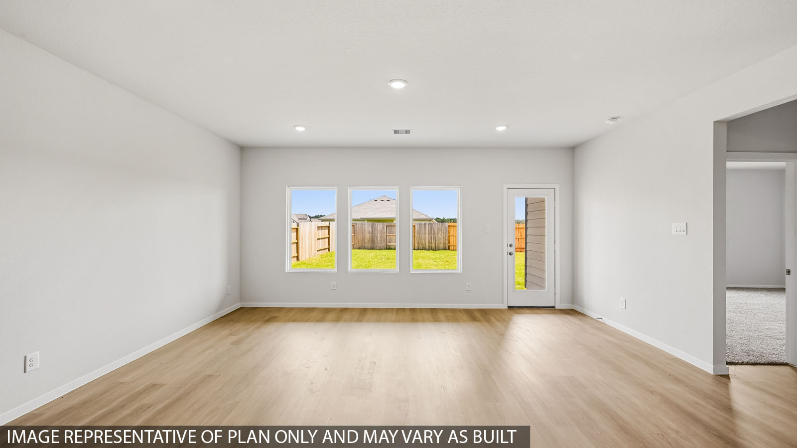 open concept living and dining area with vinyl flooring and large windows