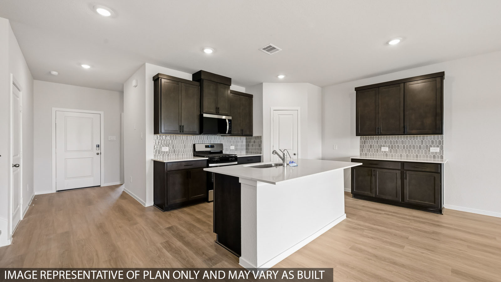 kitchen with quartz countertops, backsplash, and stainless steel appliances