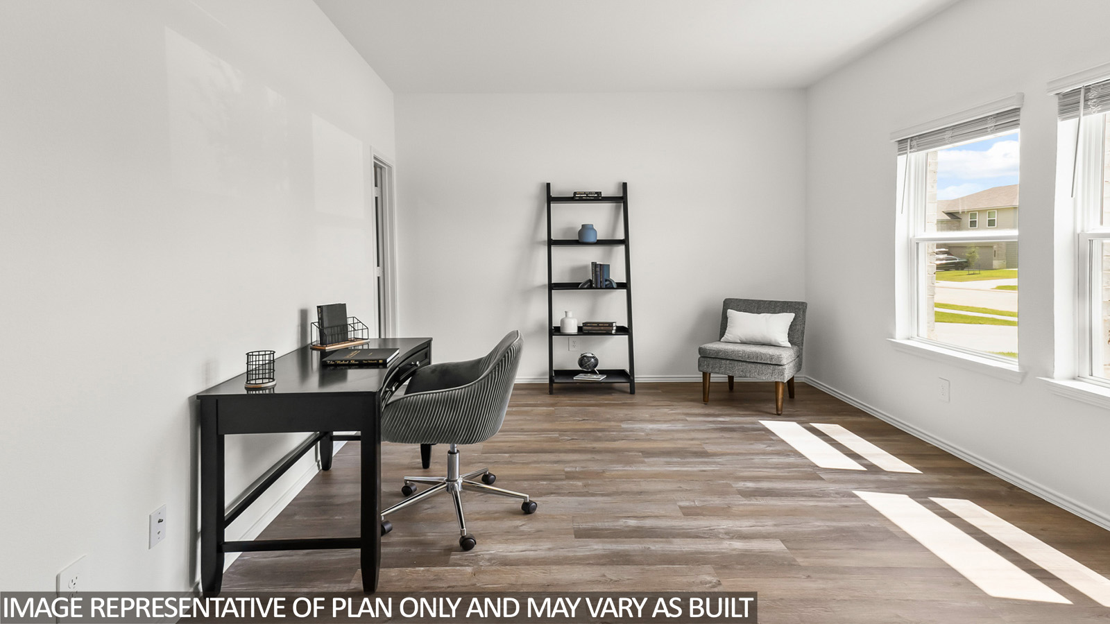 Study with windows, white walls, and vinyl wood flooring.