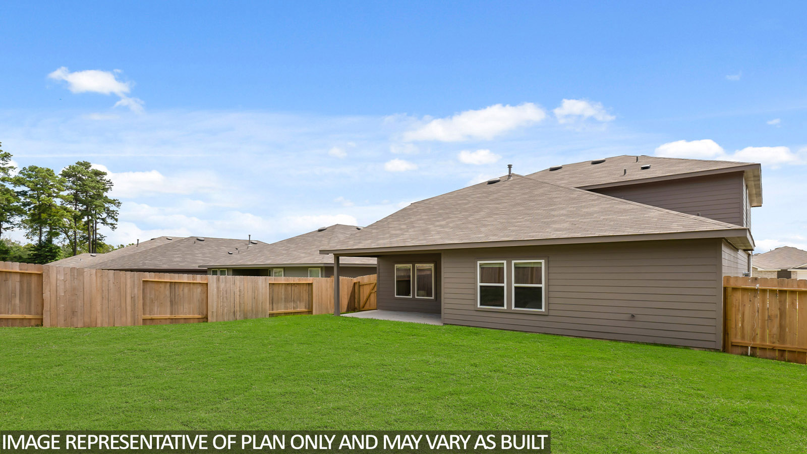 Landscaped backyard with a patio.