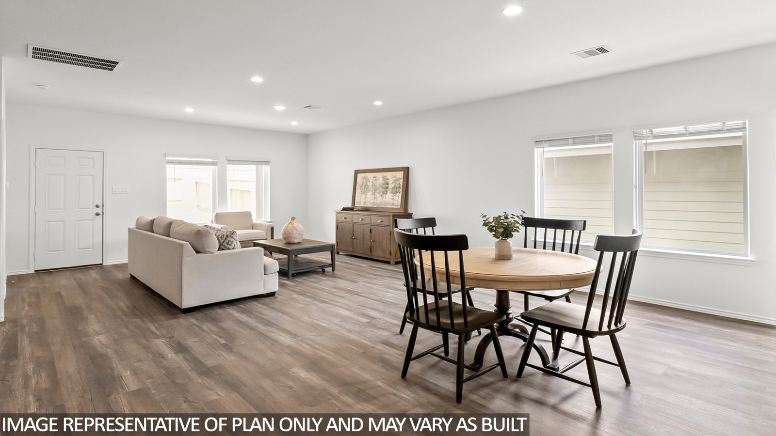 Open living room with windows, white walls, and vinyl wood flooring.