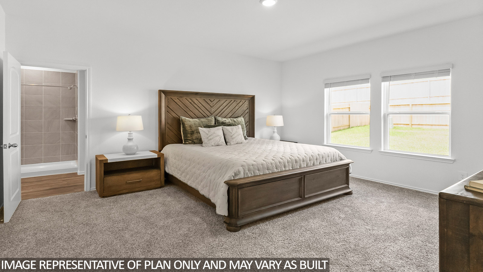 Primary bedroom with white walls, light carpet, and windows.