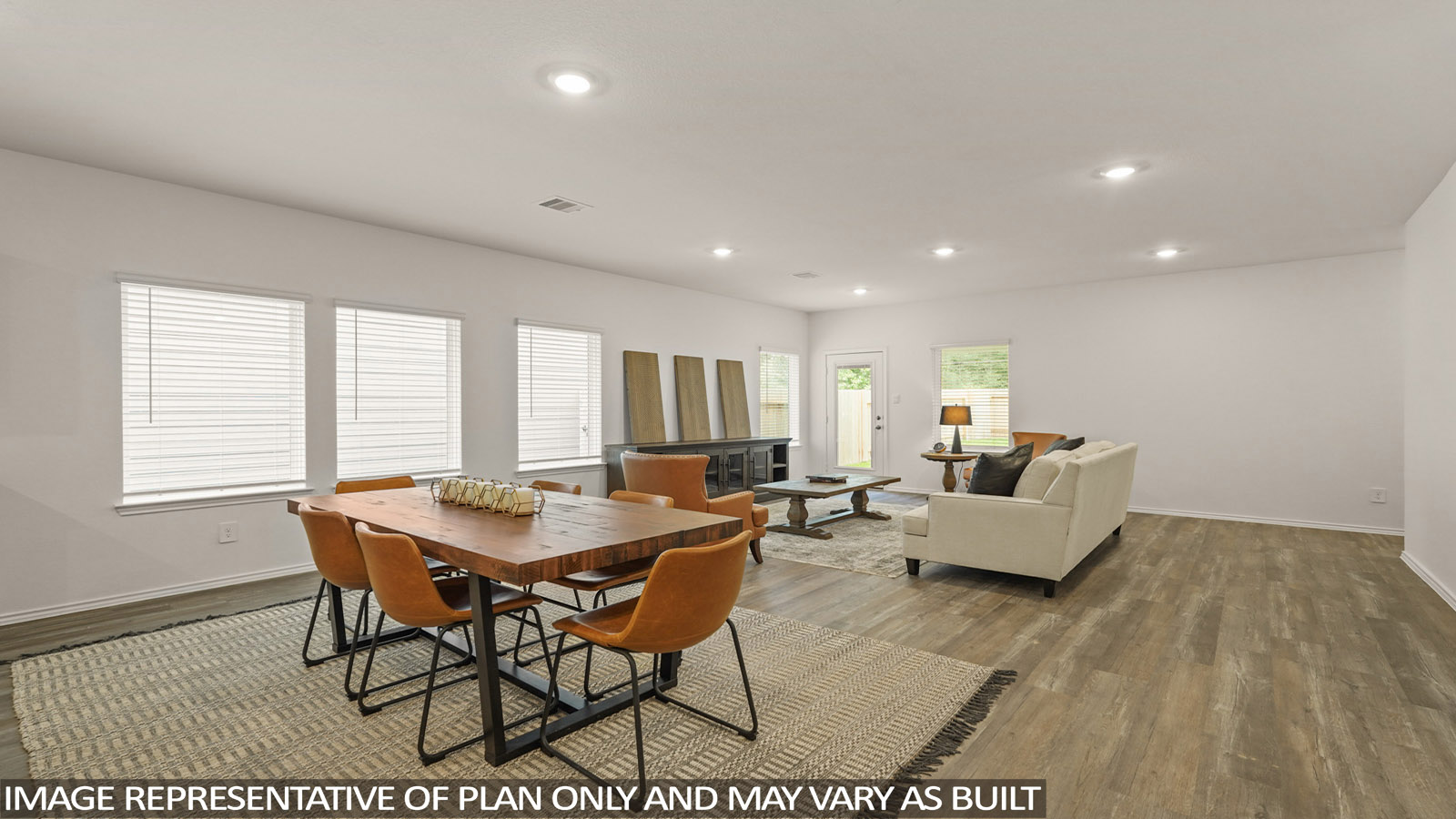 open concept living and dining area with quartz countertops, vinyl flooring and large windows