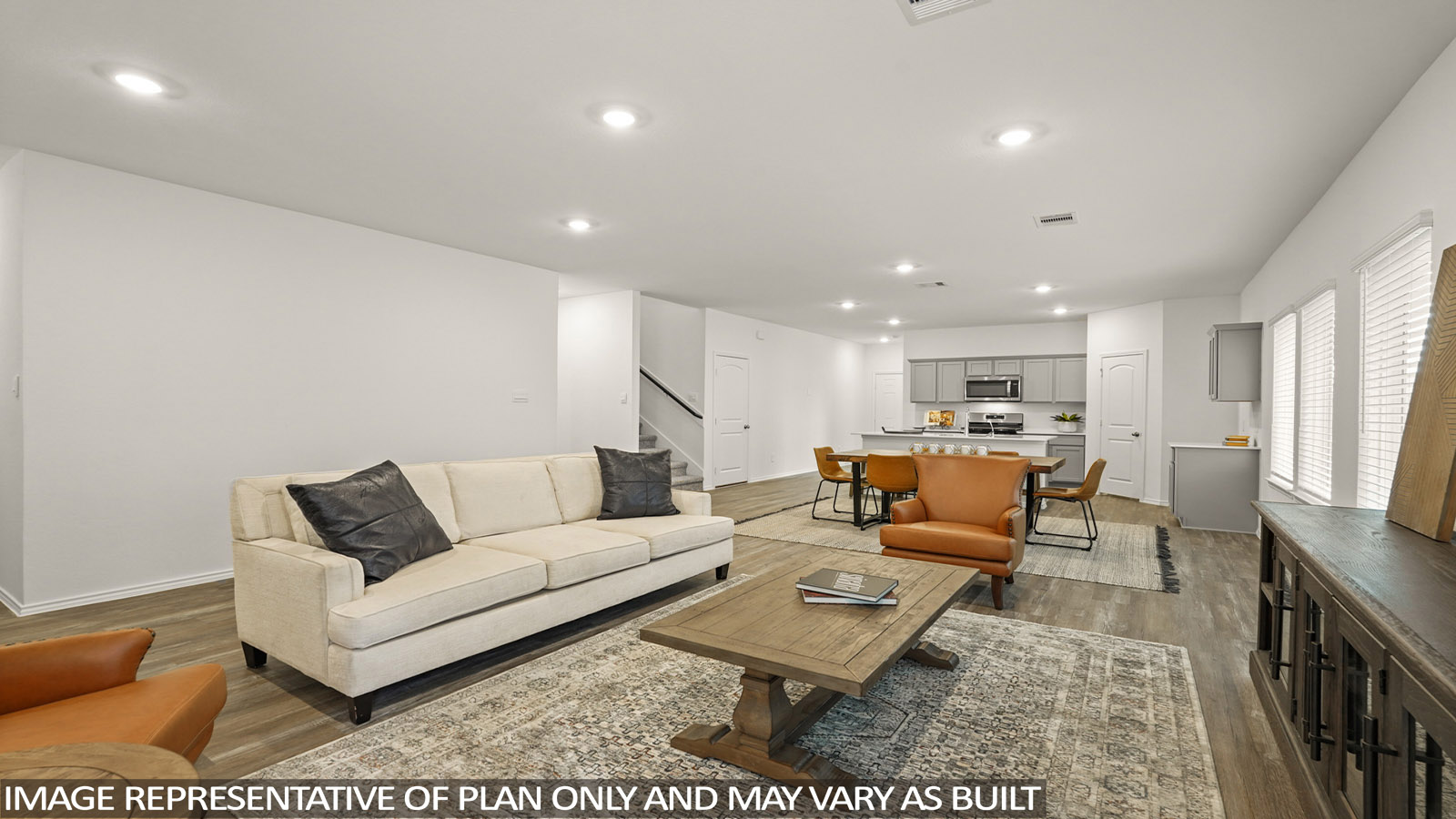 open concept living and dining area with vinyl flooring, quartz countertops, and large windows