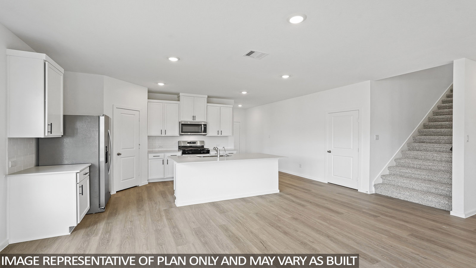 open concept living and dining area with stainless steel appliances and quartz countertops in magnolia, tx