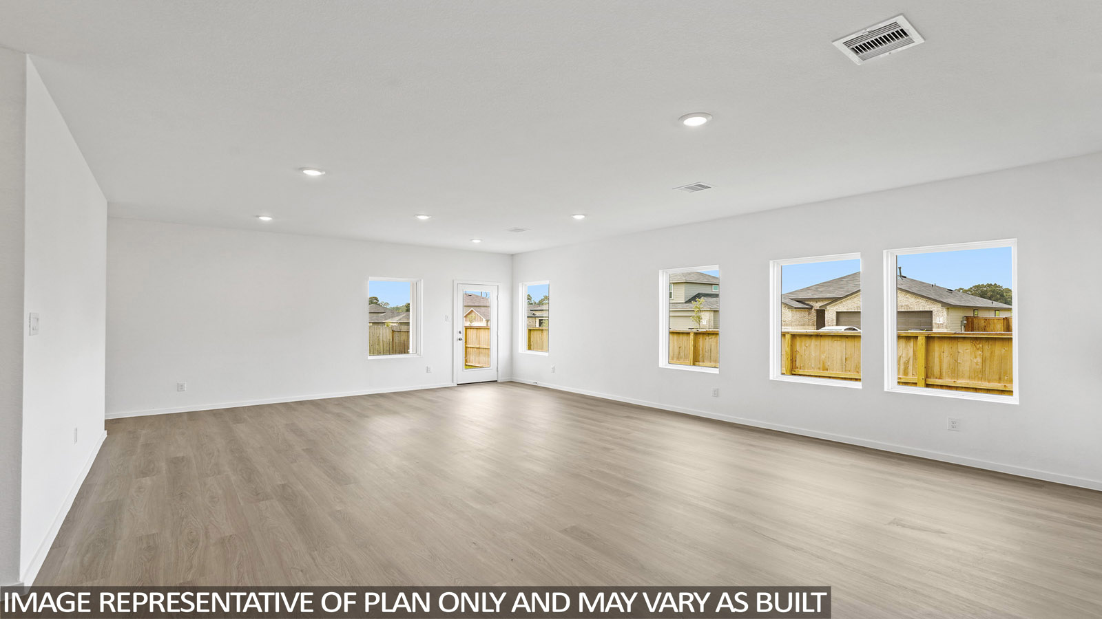 open concept living and dining area with stainless steel appliances and quartz countertops in magnolia, tx