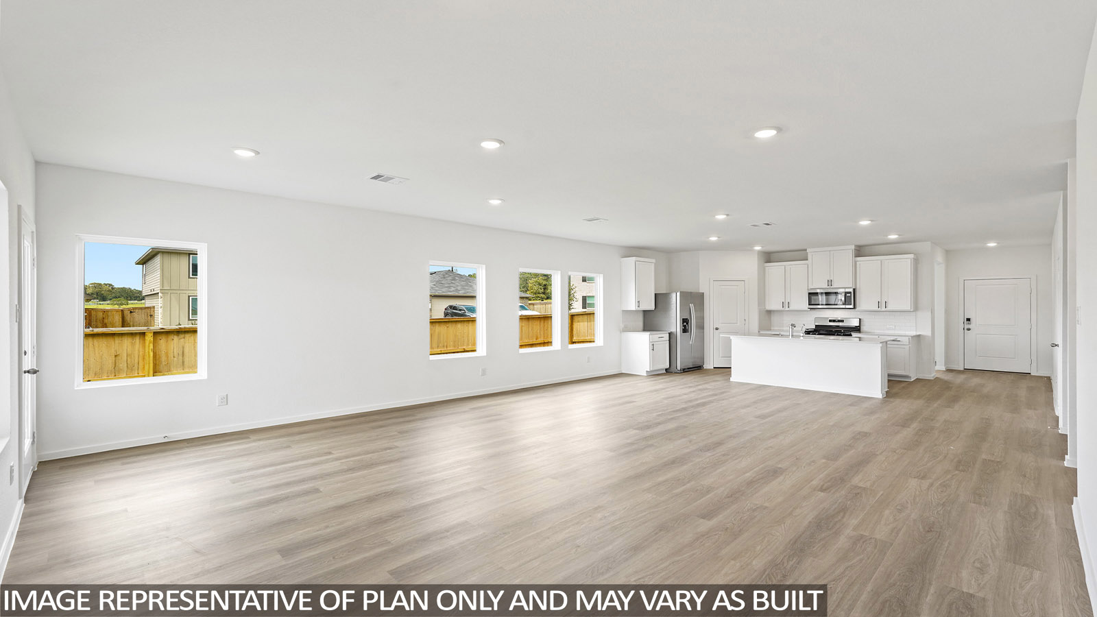 open concept living and dining area with stainless steel appliances and quartz countertops in magnolia, tx