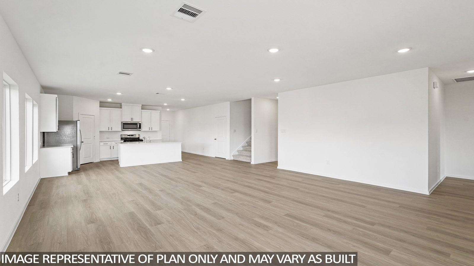 open concept living and dining area with stainless steel appliances and quartz countertops in magnolia, tx