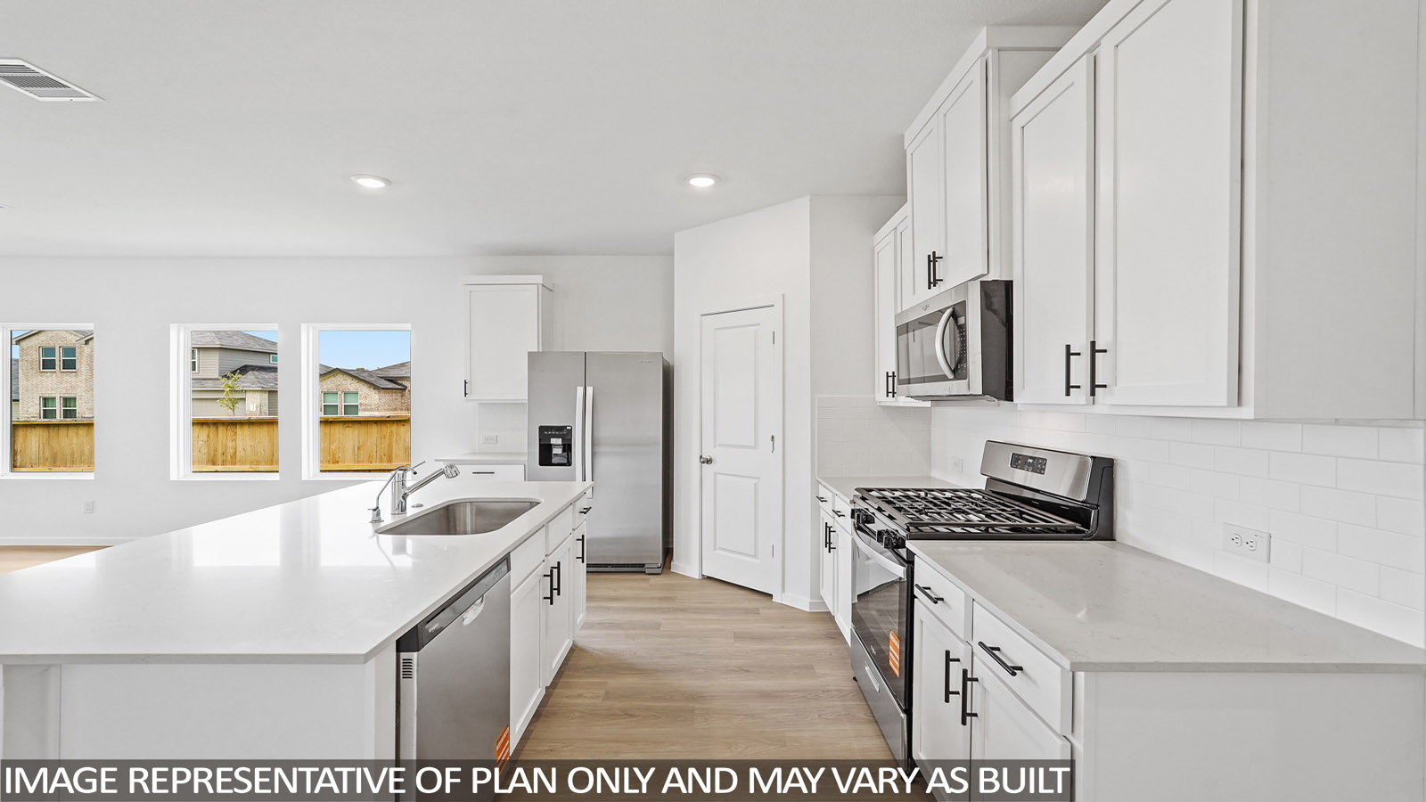 open concept living and dining area with stainless steel appliances and quartz countertops in magnolia, tx