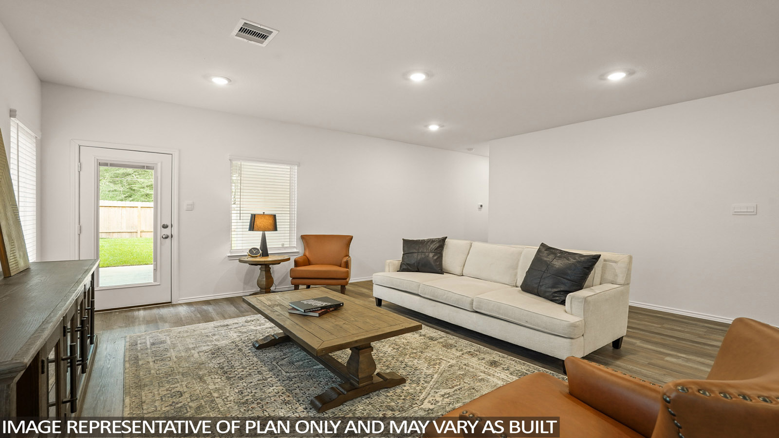 open concept living and dining area with vinl flooring, stainless steel appliances, and quartz countertops in Magnolia, TX