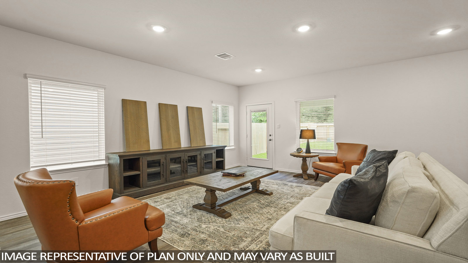 open concept living and dining area with vinl flooring, stainless steel appliances, and quartz countertops in Magnolia, TX