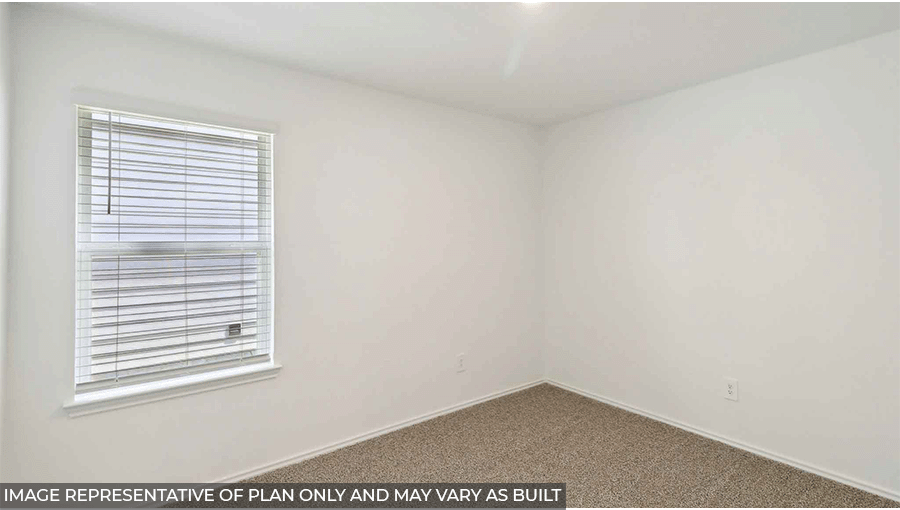 Secondary bedroom with windows, light carpet, and white walls.