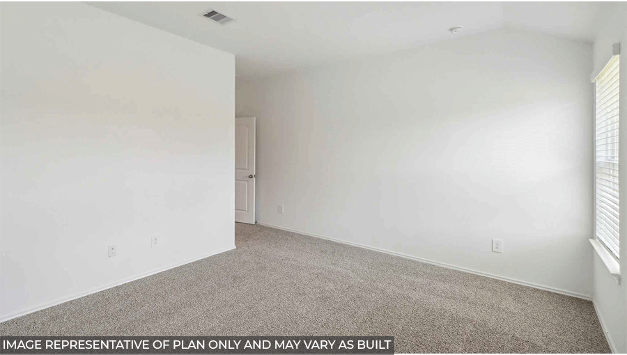 Primary bedroom with windows, light carpet, and white walls.