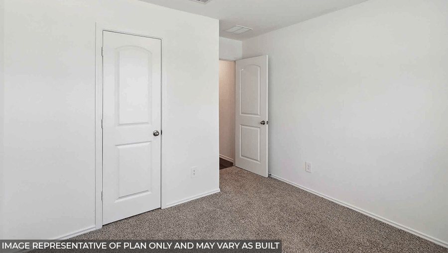 Secondary bedroom with windows, light carpet, and white walls.