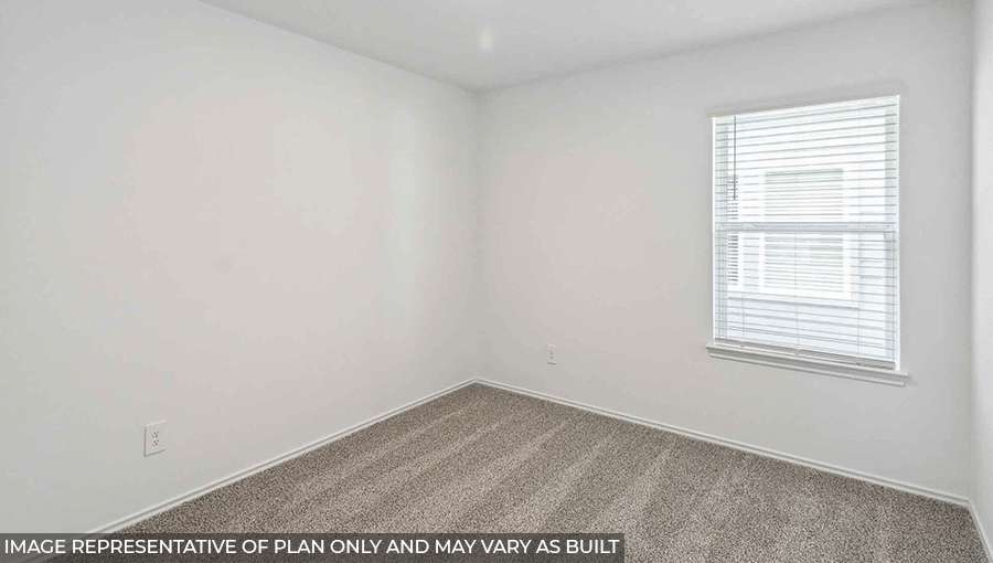 Secondary bedroom with windows, light carpet, and white walls.