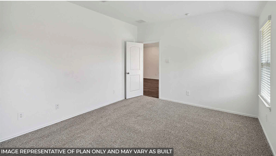 Primary bedroom with windows, light carpet, and white walls.