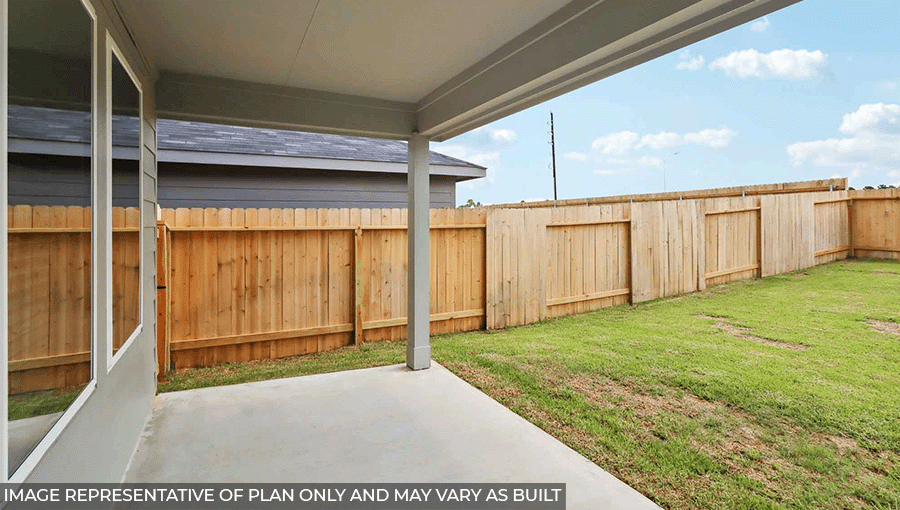 Landscaped backyard with a patio.