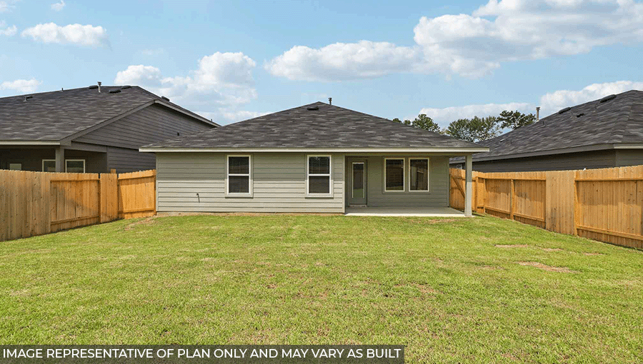 Landscaped backyard with a patio.