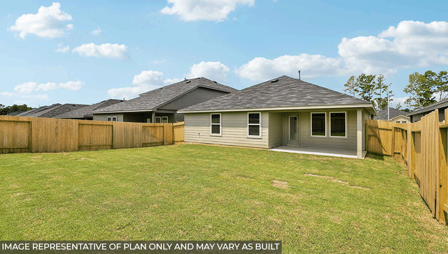 Landscaped backyard with a patio.