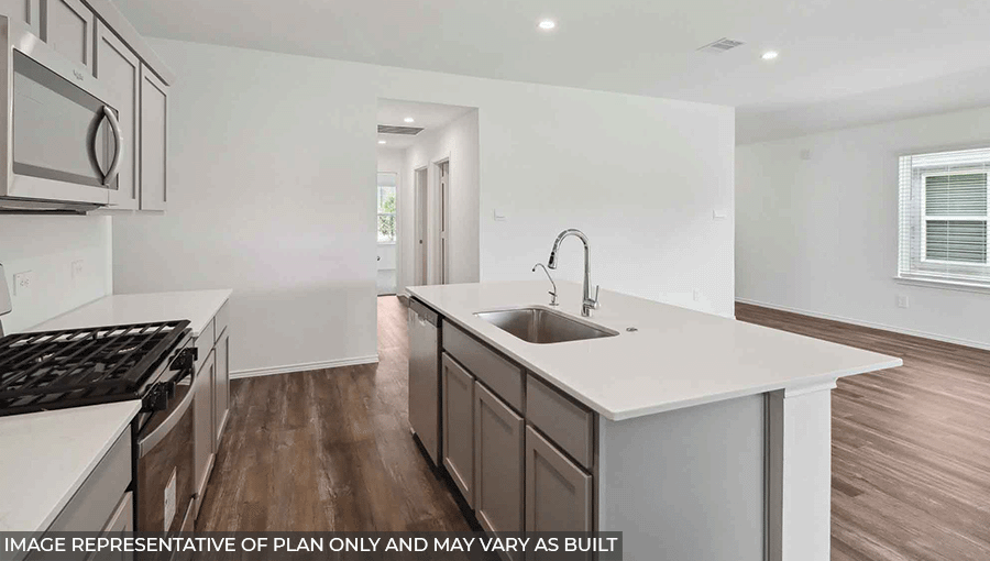Open kitchen with stainless steel appliances, light gray cabinets, white walls, an island, and vinyl wood flooring.