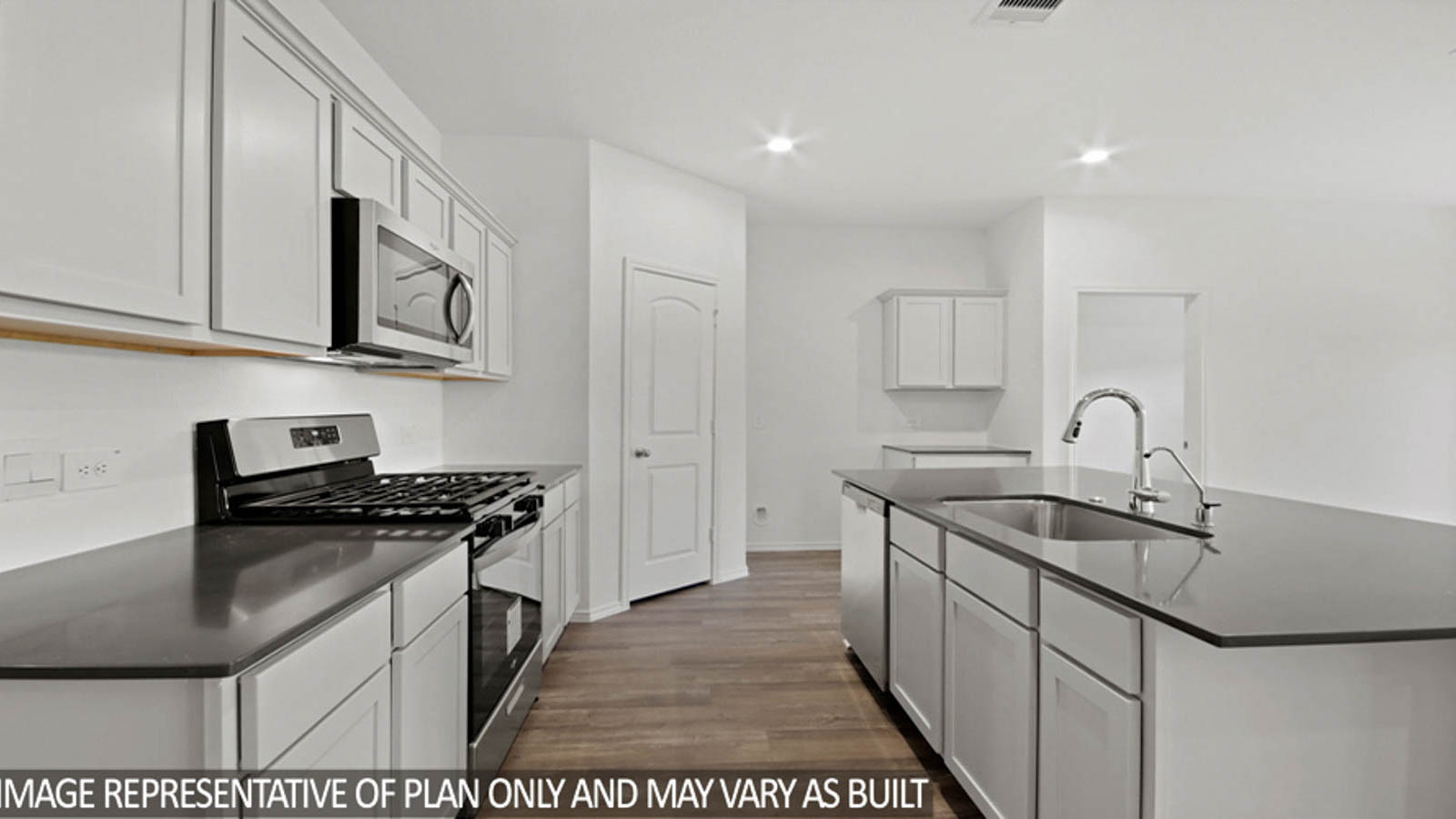 Kitchen with island and stainless-steel appliances.