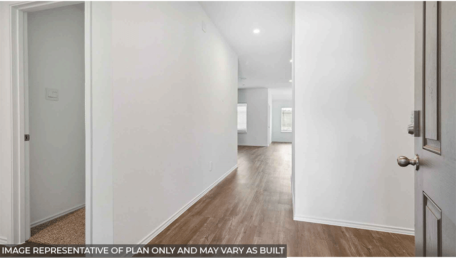 Entry hallway with white walls and vinyl wood flooring.