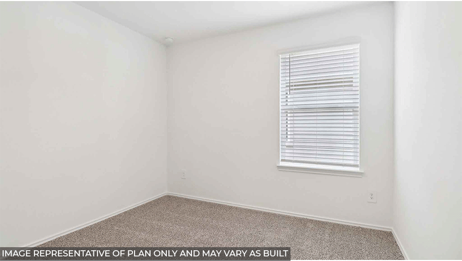 Secondary bedroom with windows, light carpet, and white walls.