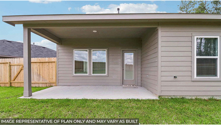 Landscaped backyard with a patio.