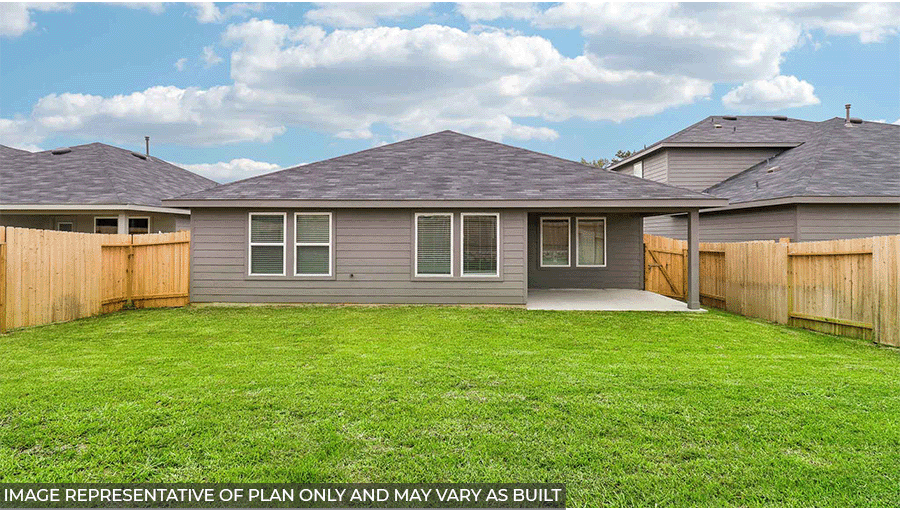 Landscaped backyard with a patio.