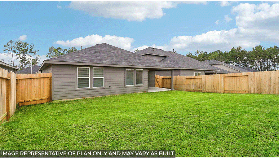 Landscaped backyard with a patio.