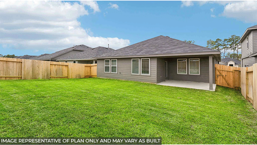 Landscaped backyard with a patio.