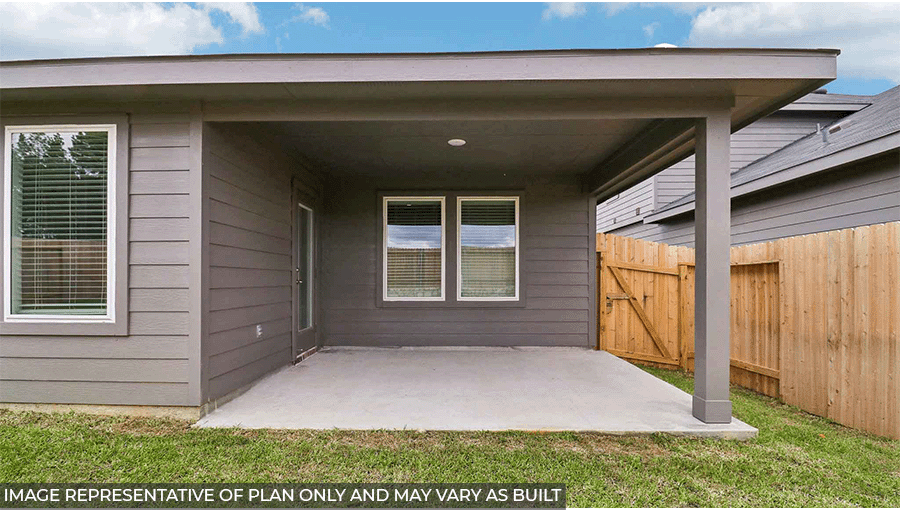 Landscaped backyard with a patio.