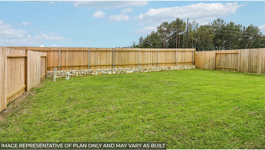 Landscaped backyard with a patio.