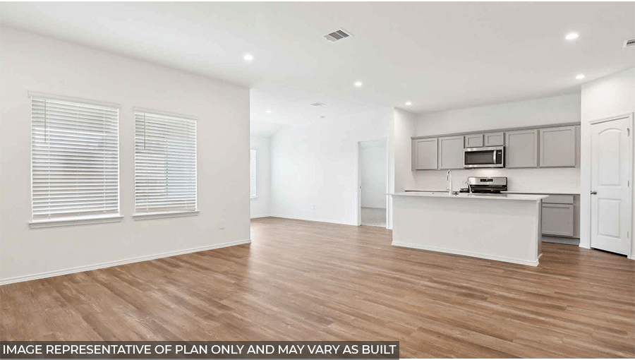 Open living room with windows, white walls, and vinyl wood flooring.