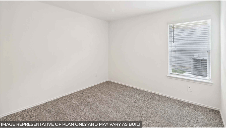 Secondary bedroom with windows, light carpet, and white walls.