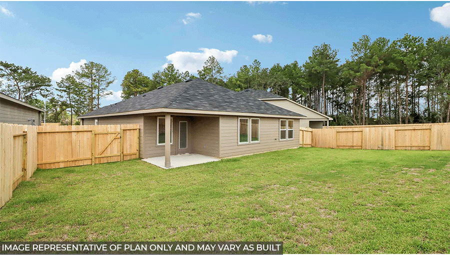 Landscaped backyard with a patio.