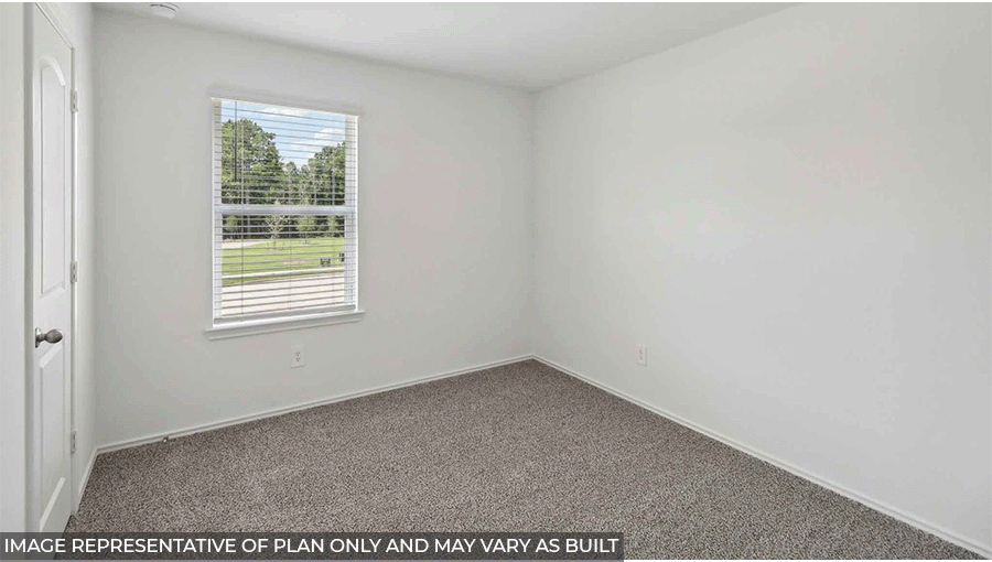 Secondary bedroom with windows, light carpet, and white walls.