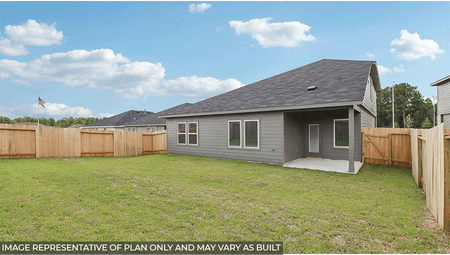 Landscaped backyard with a patio.