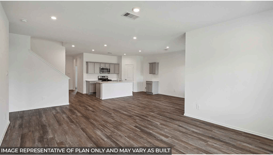 Open living room with large windows, white walls, and vinyl wood flooring.