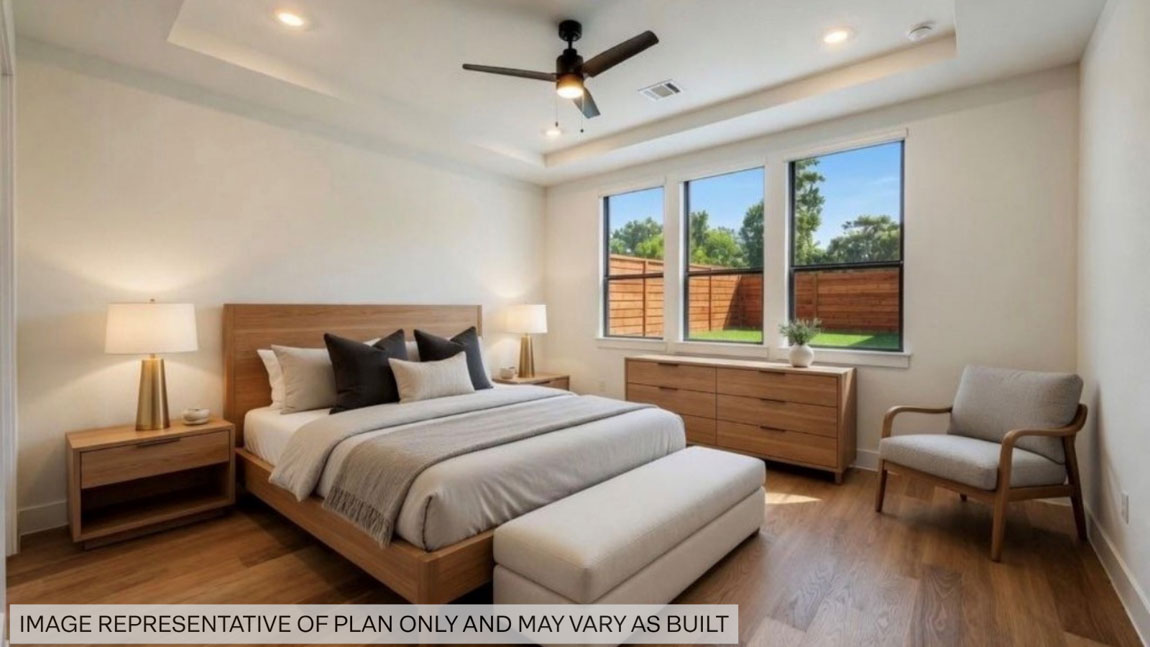 Large Primary bedroom with ceiling fan, vinyl flooring and bright window